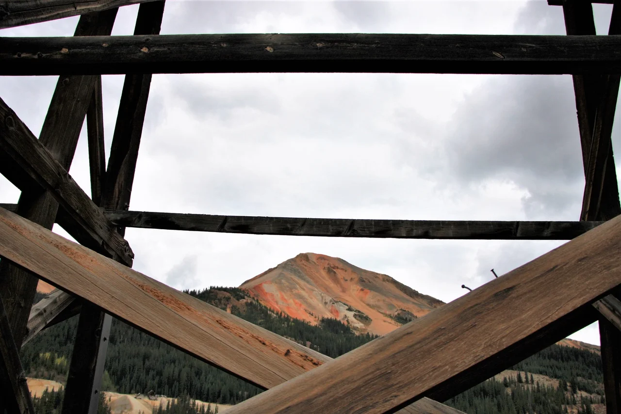 The Idarado Mine Trestle is a structure within a former mining operation in the Red Mountain Mining Distract of the San Juan Mountains of Colorado, located between Telluride and Ouray, that extracted lead, copper, zinc, gold and silver. The mine officially opened in 1939 and officially ceased in 1978. The Idarado Mine's extensive workings extended beneath the ridge with the west portal near Telluride and the eastern portal south of Ouray, Colorado. While the Idarado Mine is not on the National Register of Historic Places, its historical significance is through the Lewis Mill listing.