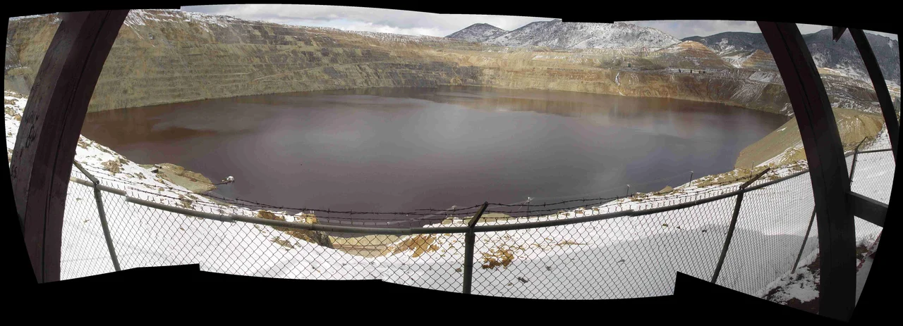 Composite fish eye view of the Berkeley Pit in Butte, Montana. Composite was created using the open source 'Hugin' application in July, 2008, combining 7 images of the Berkeley Pit taken in April of 2005.