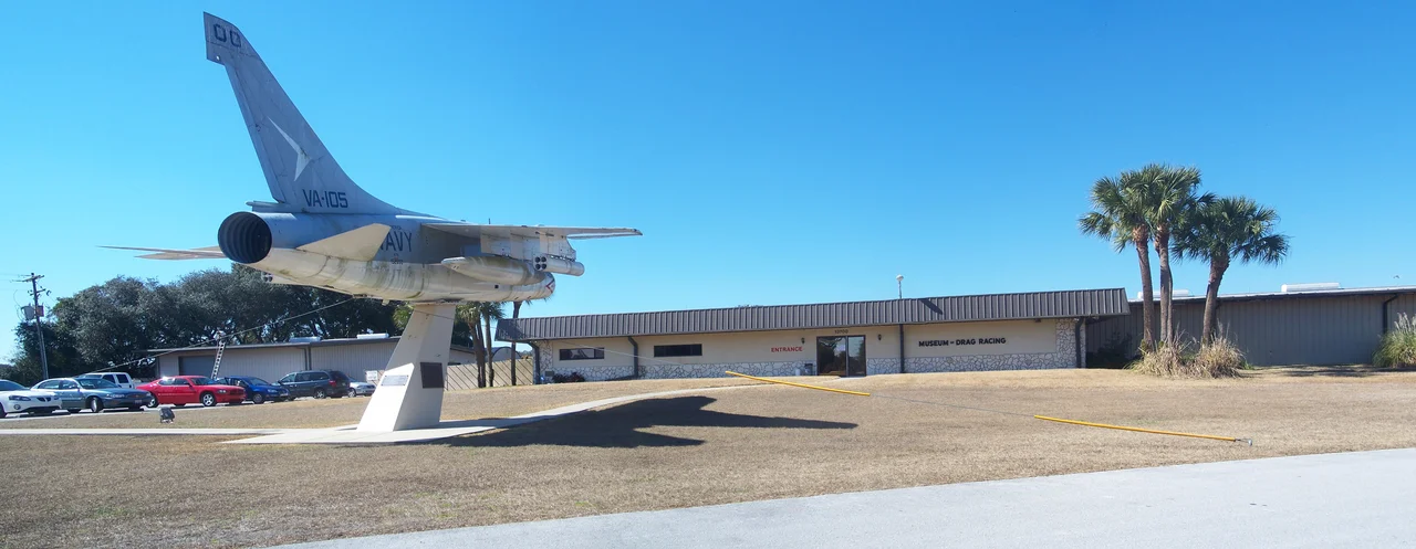 Marion County, Florida: Belleview: Don Garlits Museum of Drag Racing:
Panorama view. Includes Museum of Drag Racing building on right, and Vought A7A Corsair II BuNo 152650 on left.