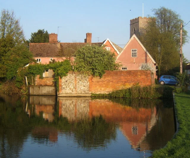 Village pond at Haughley Seen on a lovely spring evening, with an attractive group of cottages and the church beyond. The pond appears to be part of a moat system surrounding a former motte and bailey castle complex.